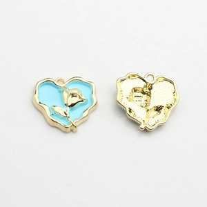 Detailed view of heart charms with blue enamel and golden rose motif on front and back