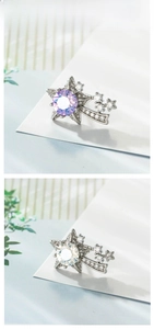 Detailed macro view of 925 silver star earrings with zircon inlay in purple and white