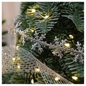 Close-up of silver snowflake chain and gold-edged mesh ribbon for Christmas DIY decor