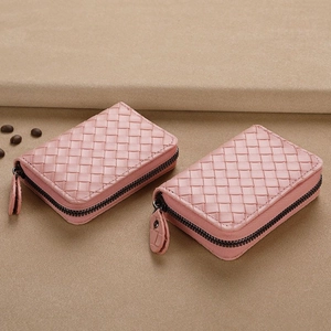 Pink woven leather card holder with zipper closure shown in front and side views