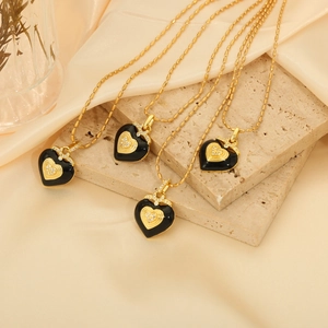Vintage heart pendant necklace in black enamel with gold plating and diamond accents