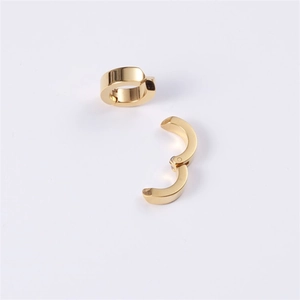 Close-up of polished gold stainless steel ear cuffs showing the side opening and texture