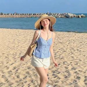 Blue and white striped camisole top with front buttons and ruffle hem at the sunny beach