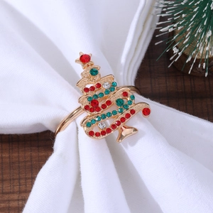 Detail view of a golden Christmas tree napkin ring with red and green rhinestones