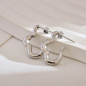 Irregular wavy silver stainless steel stud earrings with a polished minimalist aesthetic