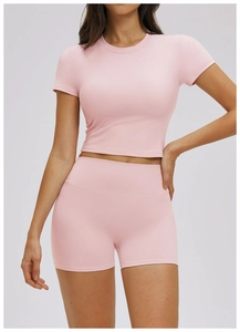 Detail of light pink ribbed fabric on women's two-piece yoga set with crop top