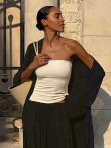 Detailed view of the ribbed fabric texture on white crop top and black long cardigan set