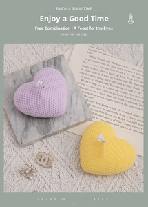 Detailed view of heart shaped candles with grid texture in purple and yellow colors
