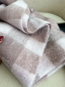 Close-up of thick plaid cashmere scarf with soft wool texture in brown and white