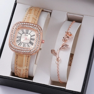 Macro shot of rose gold square quartz watch and floral bracelet in luxury gift box