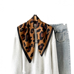 Brown leopard print small square cotton scarf styled with a white sweatshirt and denim