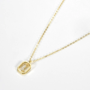 Macro shot of gold plated S925 silver necklace featuring a sparkling letter l pendant