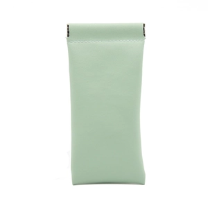 Detail view of mint green PU leather pouch with internal metal spring closure system
