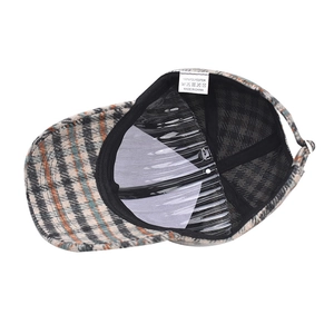 Detail view of thickened houndstooth baseball cap featuring internal lining and laundry labels