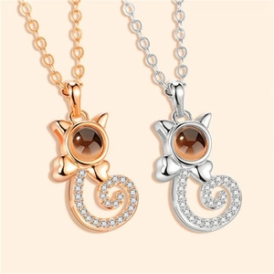 Detail of rose gold and silver cat-shaped necklaces with projection stone and zircon inlay
