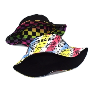 Double-sided reversible bucket hat with graffiti letter print and colorful plaid design