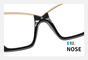 Detail of nose bridge and integrated nose pads on black and gold cat-eye glasses
