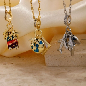 Three elegant travel-themed pendant necklaces featuring golden suitcases and silver airplanes