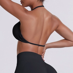 Rear view of black halter yoga set showing backless sports bra and high waist leggings