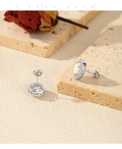Detail of oval opal earrings with zircon border and clover hollow back on stone