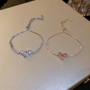 Detail of adjustable heart bracelets in silver and gold with sparkling cubic zirconia crystals