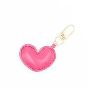 Close-up of pink heart-shaped PU leather keychain with gold lobster clasp and ring