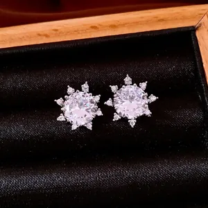 French style silver snowflake stud earrings with sparkling cubic zirconia in a jewelry box