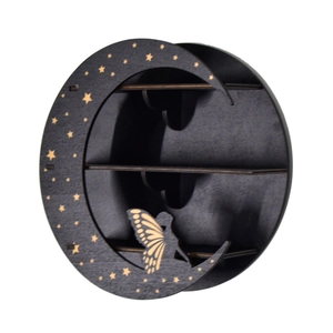 Detail of moon-shaped wooden shelf with gold star patterns and a fairy silhouette