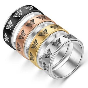 Detail of four butterfly-patterned rings in black, rose gold, gold, and silver finishes