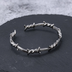 Minimalist stainless steel barbed wire open bracelet with industrial punk aesthetic