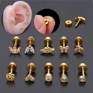 Detailed macro view of 20G gold plated ear studs with cubic zirconia and screw-back closure