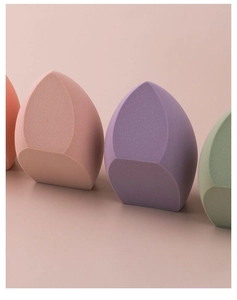 Detail of four colorful soft makeup sponges with flat-cut design for smooth makeup blending