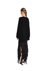 Back view of black oversized knit sweater and layered ruffle skirt set for women