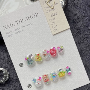 3D Christmas press-on nails featuring Santa, reindeer, and snowman icons with silver glitter