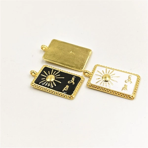Enamel Sun Tarot card necklace pendants in gold, black, and white finishes on white background