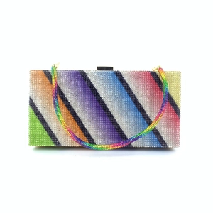 Detailed close-up of rainbow striped evening clutch bag with sparkling rhinestones