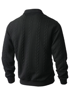 Close-up of black cable knit texture and checkered embossing on men's pullover jacket