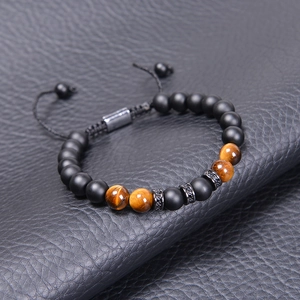 Adjustable tiger eye and matte stone bead bracelet for men on black leather background
