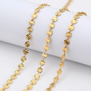 Golden 5mm embossed round disc link chains for DIY jewelry making displayed on a stand