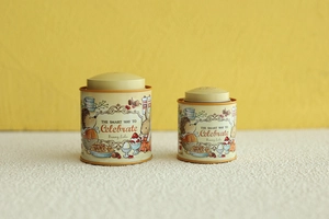 Detail of cream tin containers featuring Bunny Lulu illustrations on a white surface