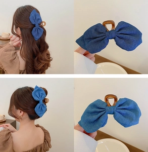 Detail of navy blue denim flower hair claw clip with brown translucent plastic grip