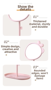 Detail showing the pink bow desktop mirror with a rotating design and storage base tray