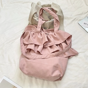 Detailed close-up of pink ruffle canvas tote bag with layered pleats and soft texture
