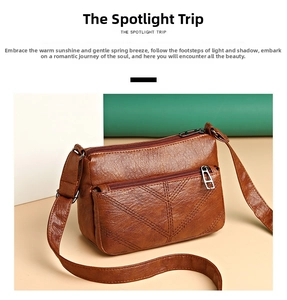 Detailed macro view of the brown faux leather texture with herringbone stitching and metal zipper
