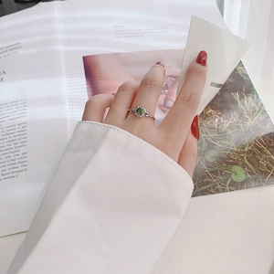 925 sterling silver sunflower ring with emerald green stone worn by a female model