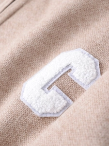 Close-up of premium toweling embroidery showing the textured letter C on knitted fabric