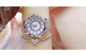 Close-up of women's silver quartz watch and crystal bow bracelet on a model's wrist