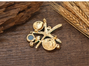 Detailed back view of gold enamel starfish brooch showing pin clasp and metallic texture