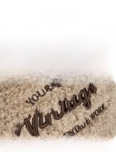 Macro detail of vintage embroidery on warm lambswool baseball cap fabric texture
