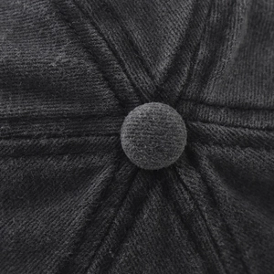 Macro shot of dark grey washed cotton baseball cap top button and twill texture detail